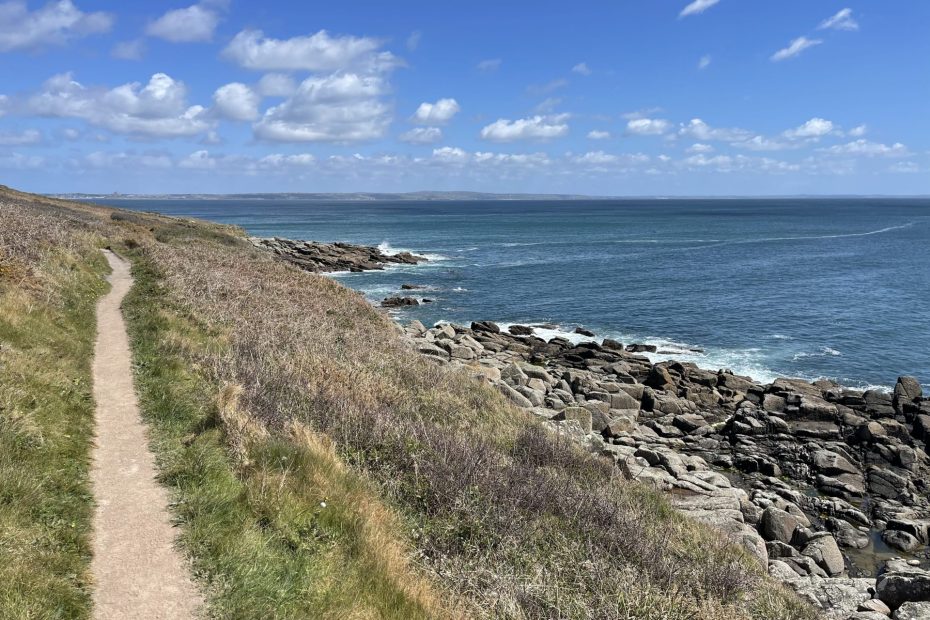 Photo of a cliff pathway where you might be breaking free from routine with a dream view over the open sea.