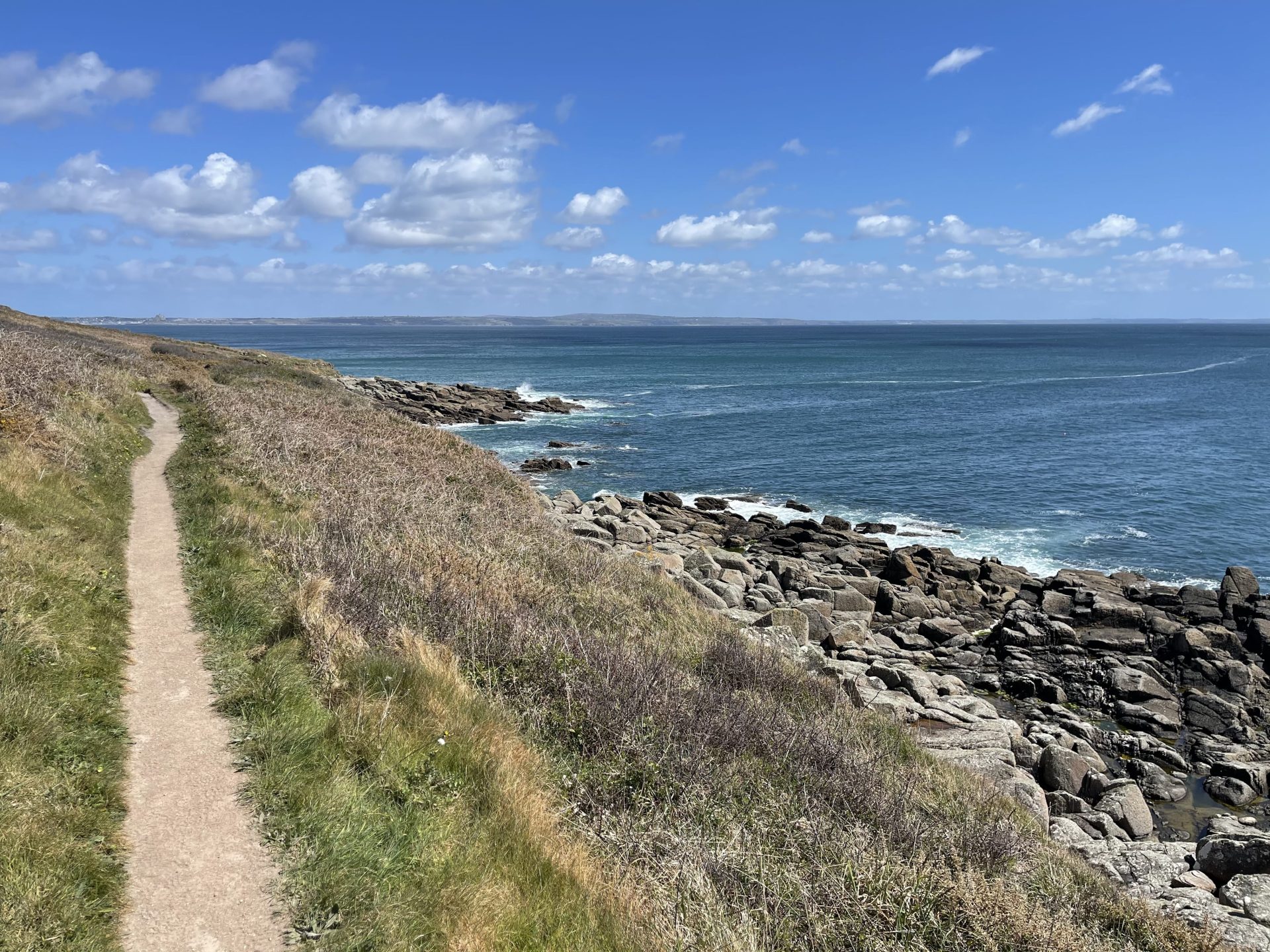 Photo of a cliff pathway where you might be breaking free from routine with a dream view over the open sea.
