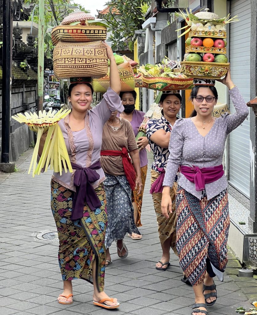 Photo of females carrying offerings on their heads for the religious festival in Ubud, Bali.