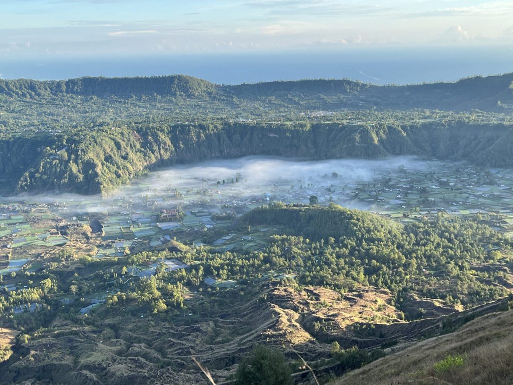 Travel photo from the top of a volcano overlooking the neighbouring valley and morning mist.