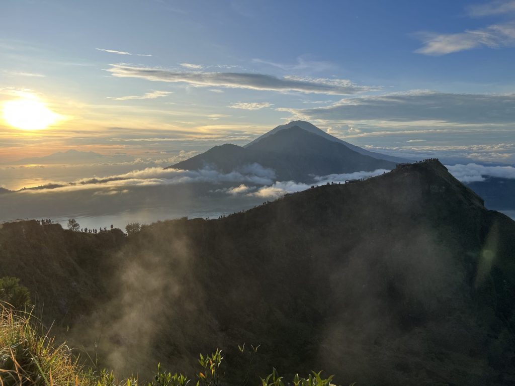 Travel photo from the Mount Batur sunrise trek overlooking the crater edge and neighbouring mountains in the distance.